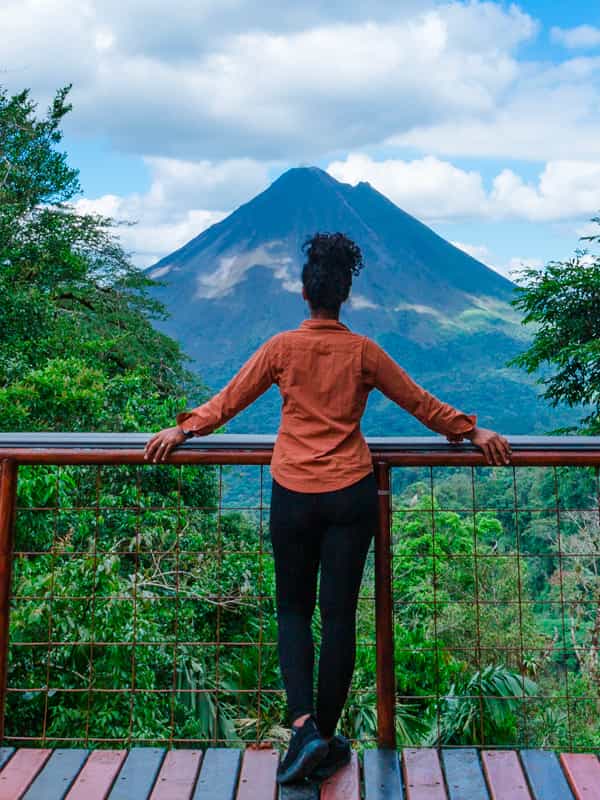 Unlock the Wonders of Arenal Park as this girl is admiring the Arenal Volcano. 