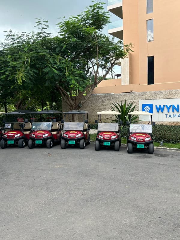 a group of golf carts parked in front of a building