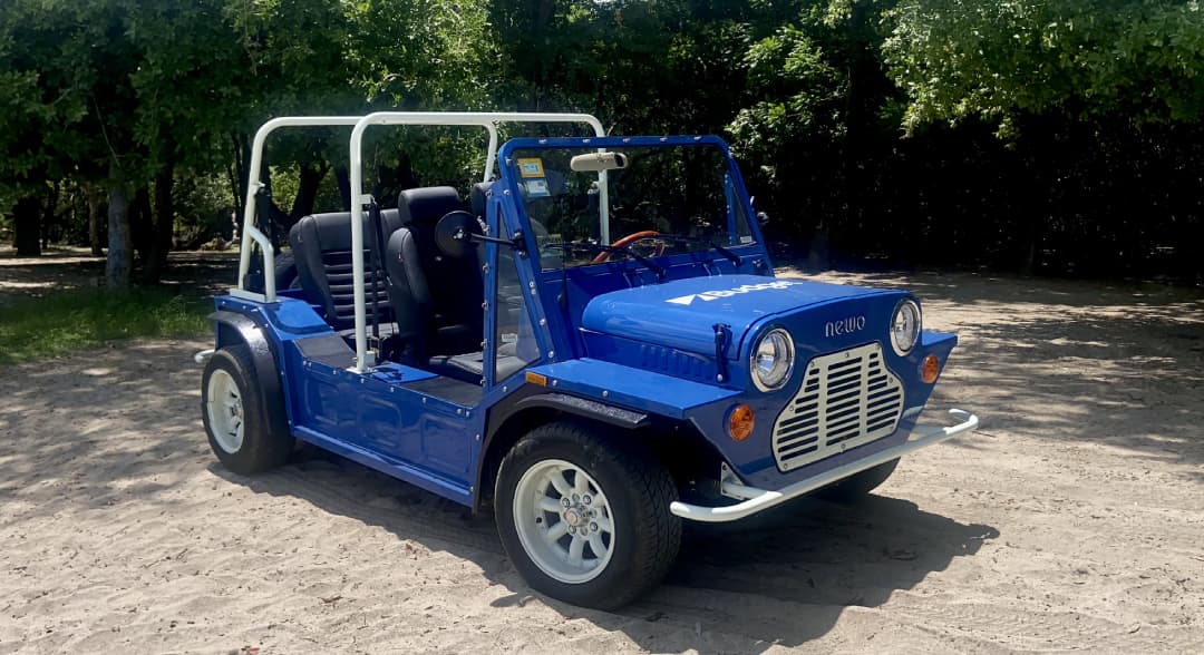 a blue car parked on sand
